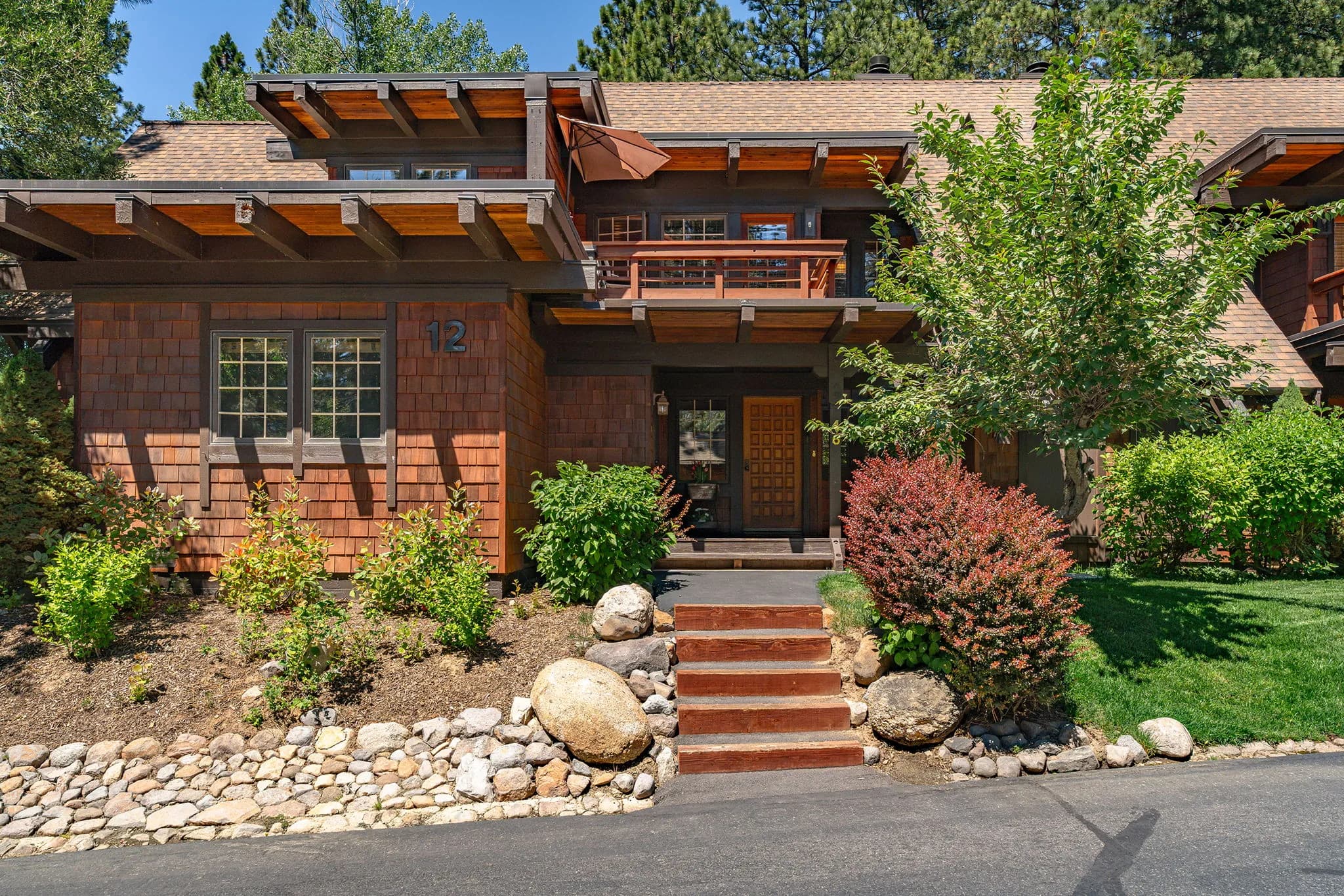 Shingle-clad Third Creek building exterior with landscaped entry path