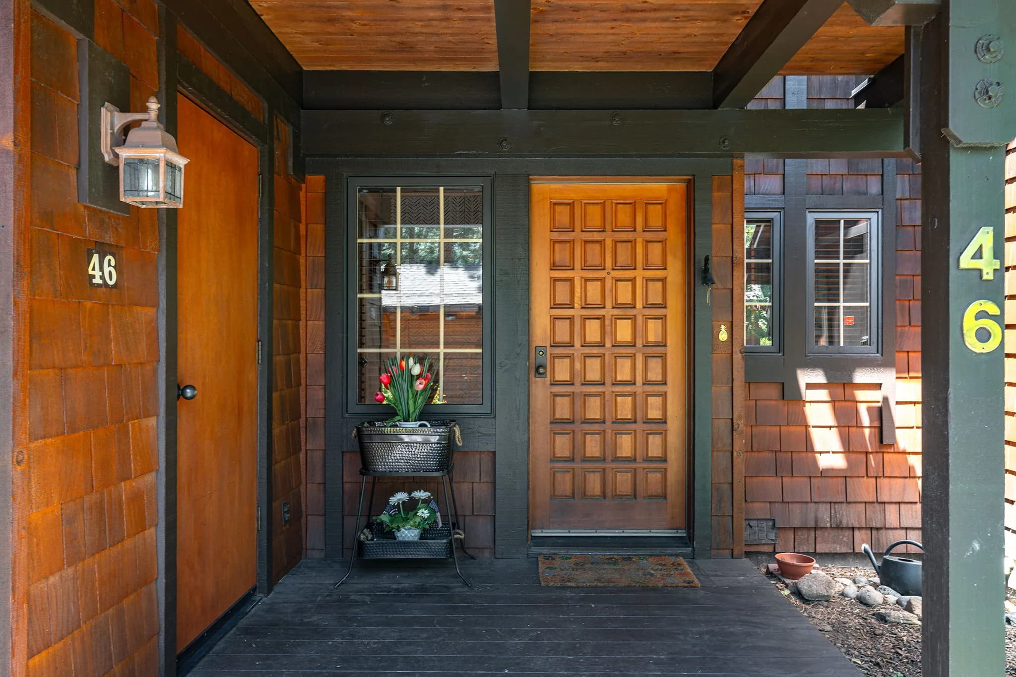 Covered wood entry porch and front door marked 46 at Third Creek