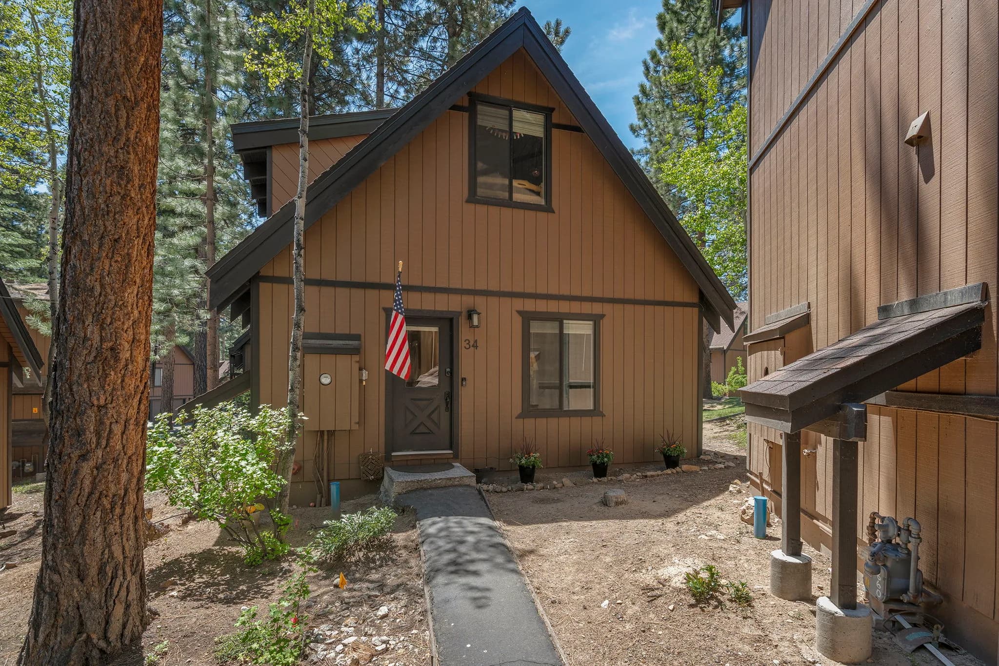 Freestanding Cedarcrest residence framed by mature pines at 930 Fairway Park Drive #34